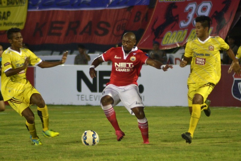 Pesepak bola Persija, Wellington Guilherme Franca JR (tengah), berebut bola dengan pesepak bola PS Polri Zulfiandi (kiri) dalam pertandingan Babak Penyisihan Grup B Sepak Bola Piala Bhayangkara di Stadion Wayan Dipta, Gianyar, Bali, Sabtu (19/3). 