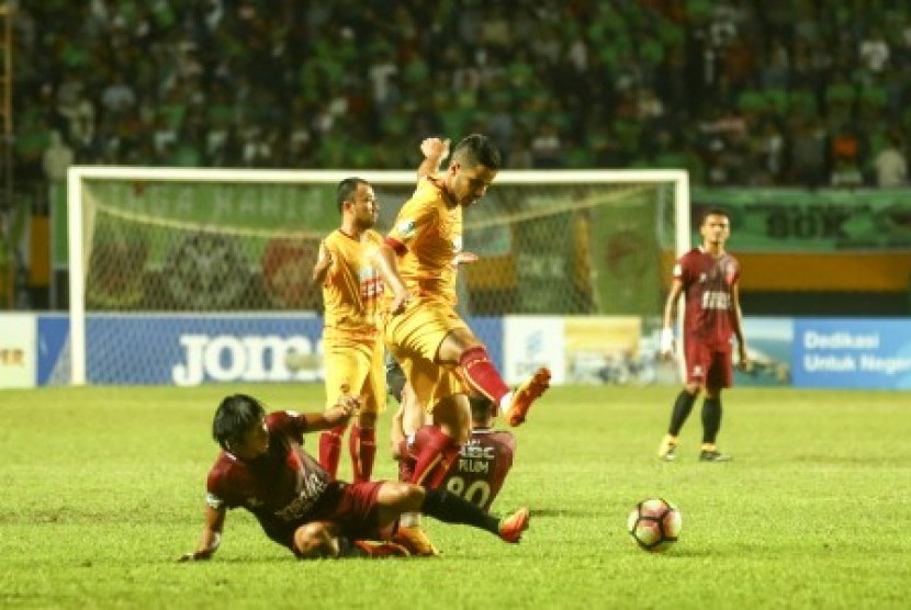 Pesepak bola Sriwijaya FC Belaid Tijani (atas) berebut bola dengan pesepak bola PSM Makassar Syamsul Bachri Haeruddin (bawah) pada pertandingan Gojek Traveloka Liga 1 di Stadion Gelora Sriwijaya Jakabaring (GSJ), Jakabaring Sport City (JSC), Palembang, Sumatera Selatan, Ahad (17/9) malam. Sriwijaya FC kalah atas tamunya PSM Makassar dengan skor 3-4.