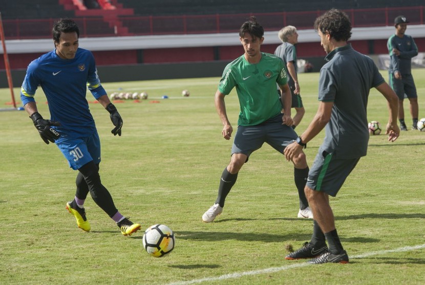 Pesepak bola Timnas U-23 Muhammad Ridho (kiri), Gavin Kwan Adsit (kedua kiri) bermain bola dengan Pelatih Luis Milla saat kegiatan pemusatan latihan (TC) perdananya di Stadion Dipta, Gianyar, Bali, Selasa (24/7).