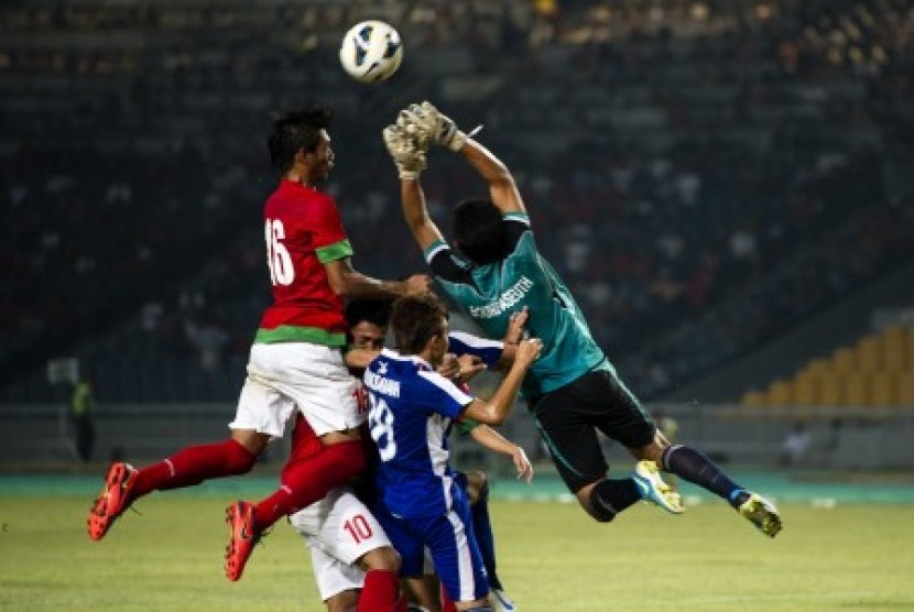 National team U-19, Hansamu Yama Pratama (left) was blocked by Laos goal keeper, Bounpaseuth Niphavong (right), during G group at AFC U-19 qualification in Gelora Bung Karno, Senayan, Jakarta, Tuesday (October 8, 2013).