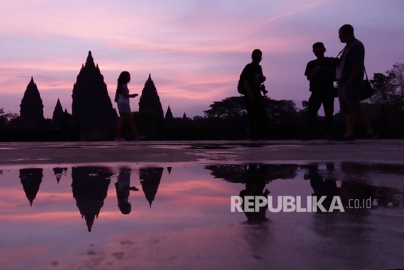 Peserta ajang Mandiri Jogja Marathon dan sejumlah pengunjung menikmati matahari terbit di Kawasan Candi Prambanan, Sleman Yogyakarta, Ahad (23/4).