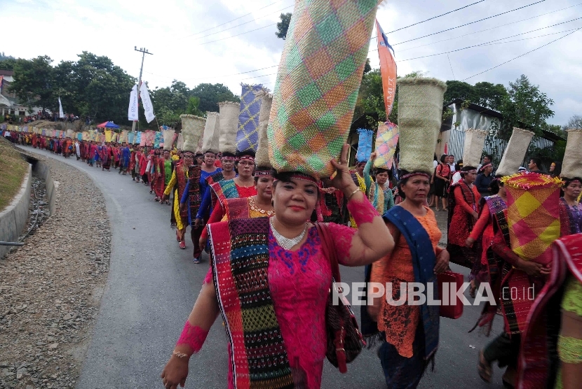 Peserta karnaval mengenakan pakaian Adat Batak mengikuti Karnaval Kemerdekaan Pesona Danau Toba, Balige, Sumatra Utara, Ahad (22/8).