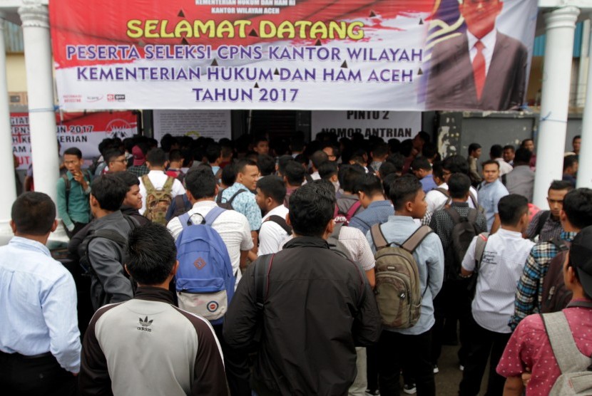 Peserta ujian Calon Pegawai Negeri Sipil (CPNS) Kementerian Hukum dan HAM wilayah Aceh antre seleksi pengukuran tinggi badan di Banda Aceh, Aceh, Senin (11/9).