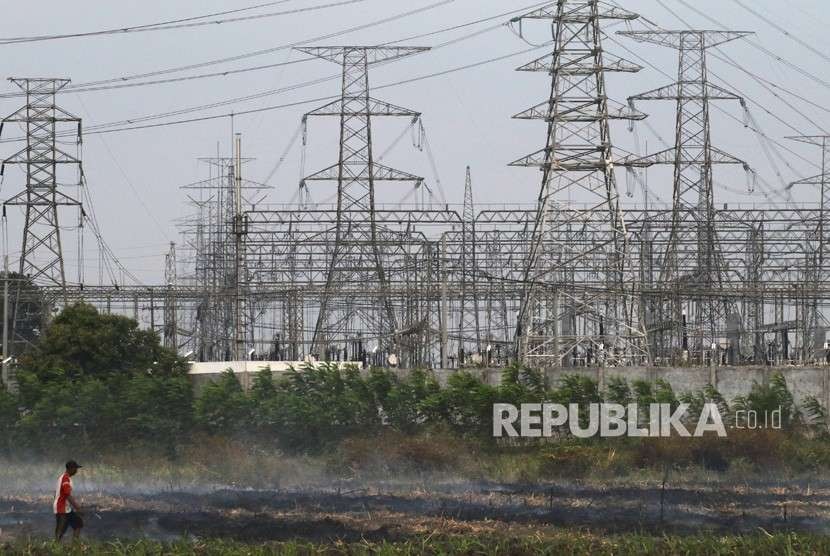 Petani membakar lahan dengan latar belakang Gardu Induk Tegangan Ekstra Tinggi (Gitet) transmisi Jawa bagian timur dan Bali (ilustrasi). PT PLN Unit Induk Distribusi (UID) Jawa Timur bersiap mengoperasikan Trafo 3 GITET Krian.