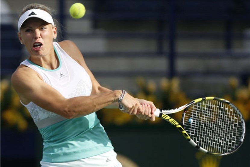 Petenis Caroline Wozniacki mengembalikan pukulan bola petenis Sabine Lisicki dalam laga putaran pertama turnamen WTA Dubai pada Selasa (18/2). 