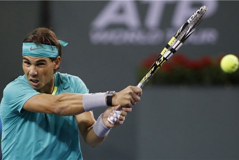 Petenis Spanyol, Rafael Nadal, melepaskan pukulan kerasnya saat menghadapi petenis Amerika Serikat, Ryan Harrison, di turnamen BNP Paribas Terbuka di Indian Wells, California, Sabtu (9/3).  