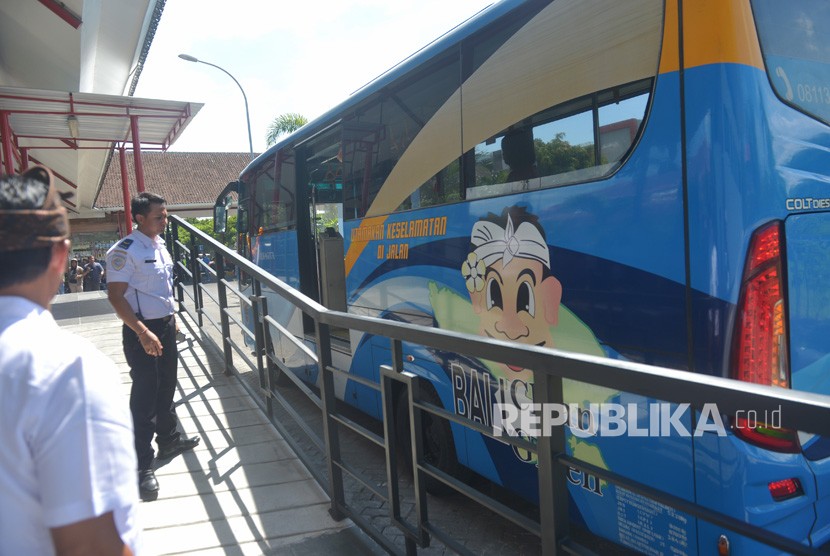 Petugas bandara memandu sopir bus Trans-Sarbagita berhenti di posisi yang telah ditentukan di halte menjelang peluncuran transportasi massal di Bandara I Gusti Ngurah Rai, Denpasar, Bali, Kamis (2/5/2019).