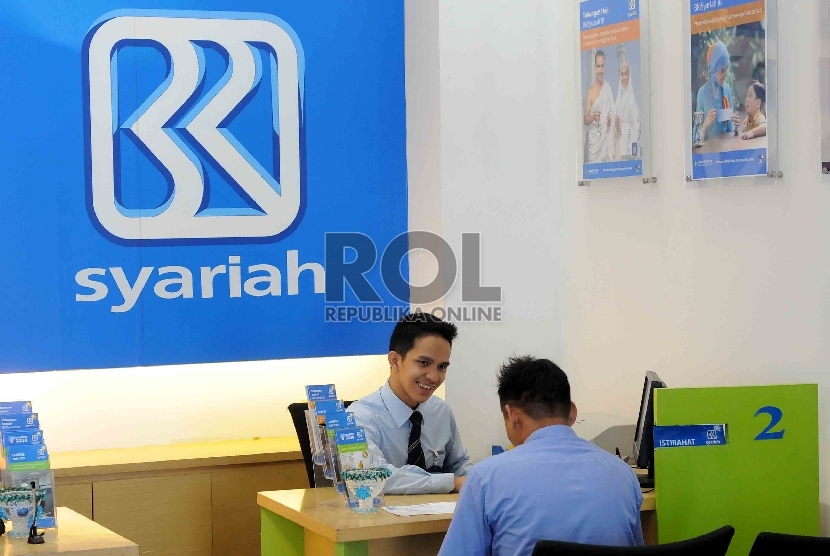 Petugas bank melayani nasabah di kantor BRI Syariah, Jakarta, Rabu (12/8). 