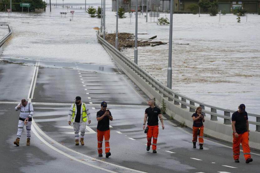 Petugas berdiri di dekat jembatan Windsor yang terendam air di pinggiran Sydney, Australia, Kamis (3/3/2022).