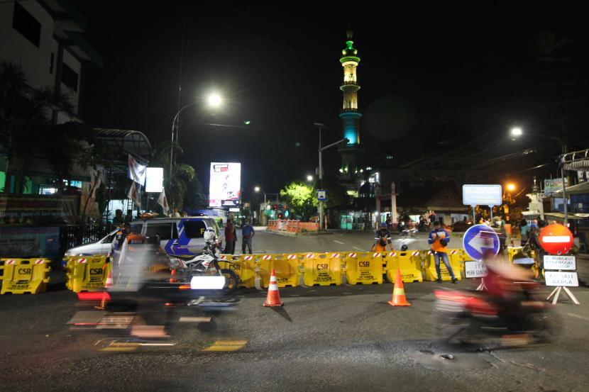 Petugas berjaga di Jalan Rungkut Menanggal yang ditutup di Surabaya, Jawa Timur, Kamis (4/6/) malam. 