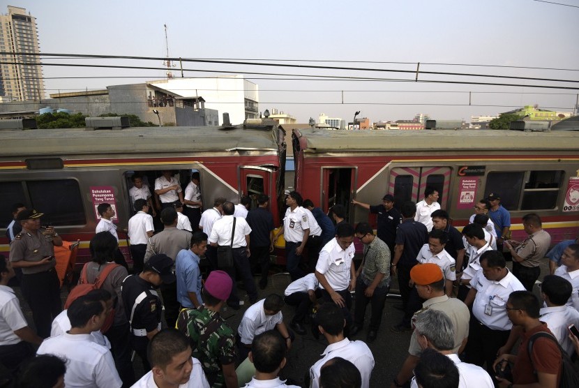 Petugas berusaha mengevakuasi barang dan penumpang yang ada di gerbong ketika terjadi tabrakan Kereta Rel Listrik (KRL) di Stasiun Juanda, Rabu (23/9).