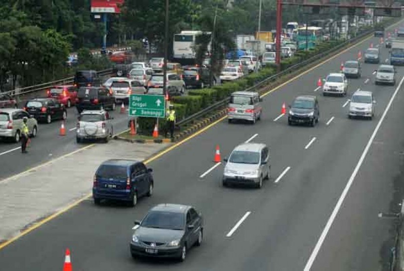  Petugas dari Kepolisian membantu mengatur arus lalu lintas di tol dalam kota di Kawasan Semanggi saat uji coba contra flow atau sistim melawan arus lalu lintas di Jakarta, Selasa (1/5). 