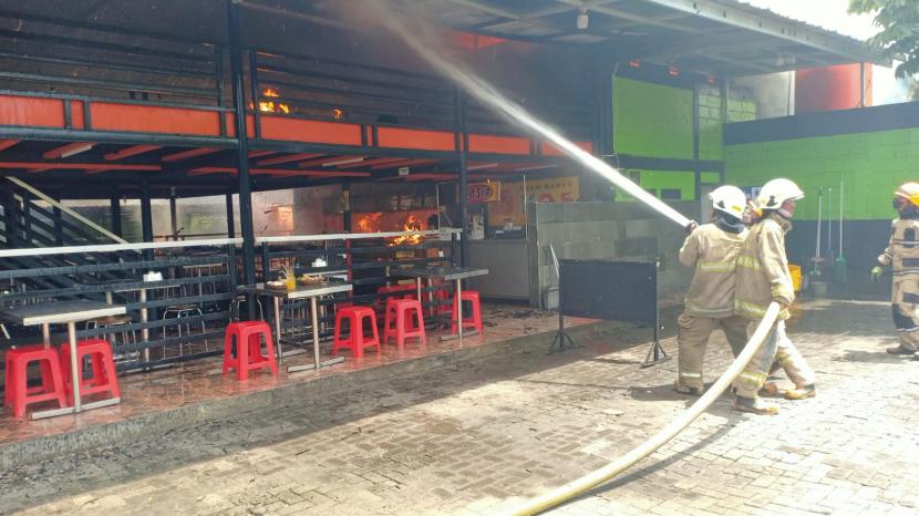Petugas Dinas Kebakaran dan Penanggulangan Bencana (Diskar PB) Kota Bandung melakukan pemadaman kebakaran di Rumah Makan Ampera, Jalan Soekarno Hatta, Kota Bandung, Kamis (12/1/2023).