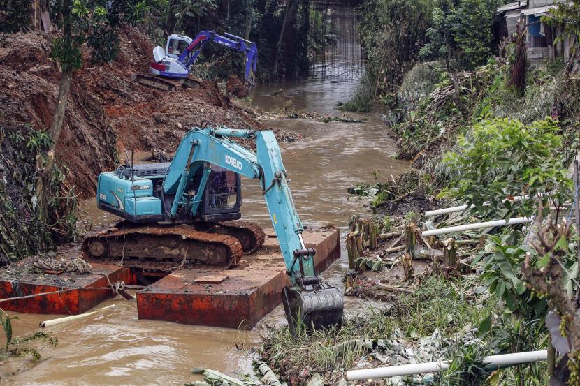 Petugas Dinas Pekerjaan Umum dan Penataan Ruang mengoperasikan alat berat untuk mengangkut sampah dan lumpur yang menumpuk di aliran sungai Kali Baru, Cibinong, Kabupaten Bogor, Jawa Barat, Senin (10/10/2022). Normalisasi sungai tersebut sebagai langkah antisipasi banjir di musim hujan. 