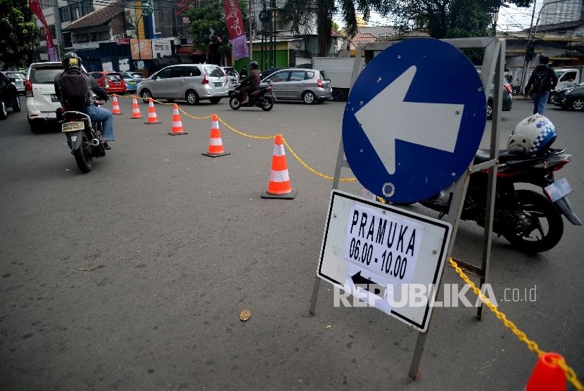 Petugas Dinas Perhubungan mengarahkan kendaraan saat di berlakukannya uji coba rekayasa lalul intas di simpang Jalan Proklamasi, Jakarta, Kamis (8/6).