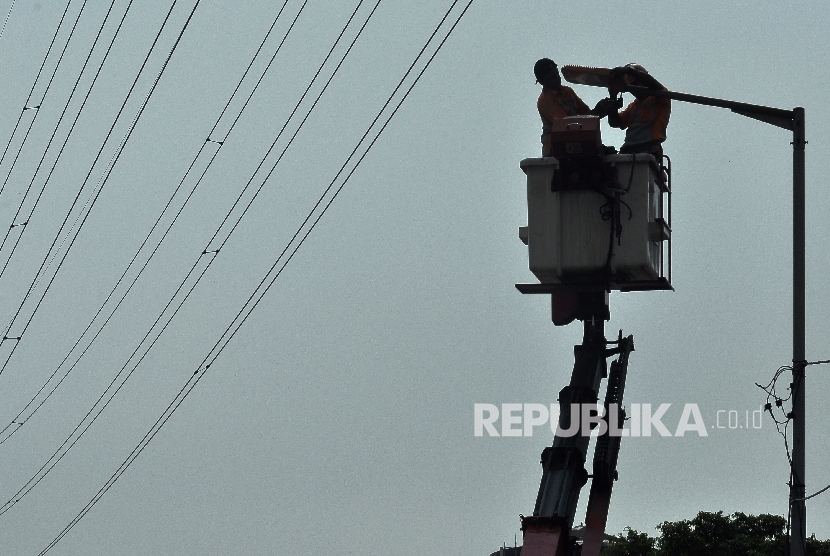 Petugas Dinas Perindustrian dan Energi mengganti lampu penerangan jalan umum (PJU) di kawasan Jalan Kali Sekretaris, Jakarta Barat, Senin (21/8).