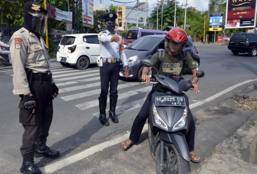 10 Jalan di Bandar Lampung Ditutup pada Malam Tahun Baru. Petugas gabungan memberhentikan penguna jalan yang tidak mengenakan masker saat razia masker di sejumlah jalan protokol di Bandar Lampung, Lampung, Kamis (13/8/2020). 