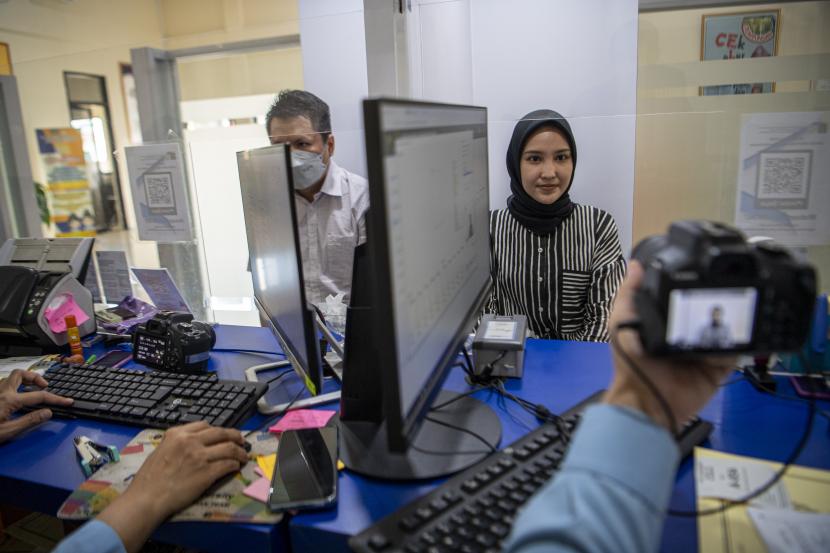 Petugas imigrasi merekam wajah pemohon pembuatan paspor di Kantor Imigrasi Kelas I TPI Palembang, Sumatra Selatan, Senin (25/4/2022).