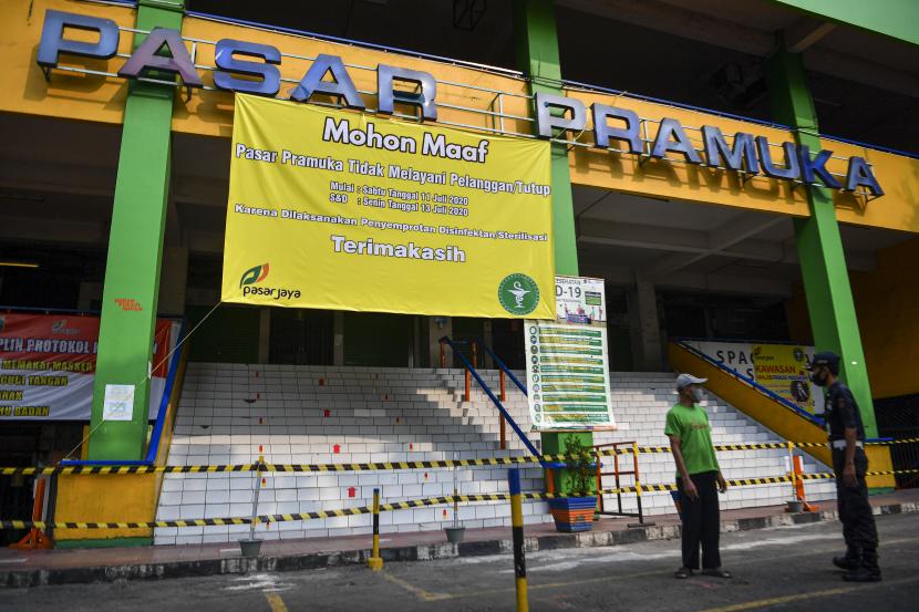 Petugas keamanan berbincang dengan warga di depan Pasar Pramuka, Jakarta, Ahad (12/7). Pengelola Pasar Pramuka menutup sementara pasar tersebut dari Sabtu (11/7) hingga Senin (13/7) menyusul satu orang pedagang terkonfirmasi positif Covid-19. (ilustrasi)