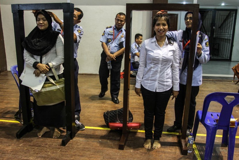 Petugas kemenkumHAM Riau mengukur tinggi badan peserta pada proses verifikasi dokumen dan pengukuran tinggi badan seleksi Calon Pegawai Negeri Sipil (CPNS) KemenkumHAM Riau di Pekanbaru, Riau, Senin (11/9).