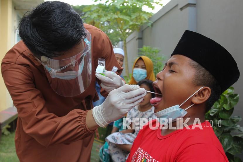 Petugas kesehatan melakukan tes usap PCR COVID-19 kepada santri di Puskesmas Sawah Pulo, Surabaya, Jawa Timur, Senin (24/5/2021). Tes usap tersebut sebagai syarat bagi para santri untuk kembali mengikuti kegiatan belajar di pondok pesantren