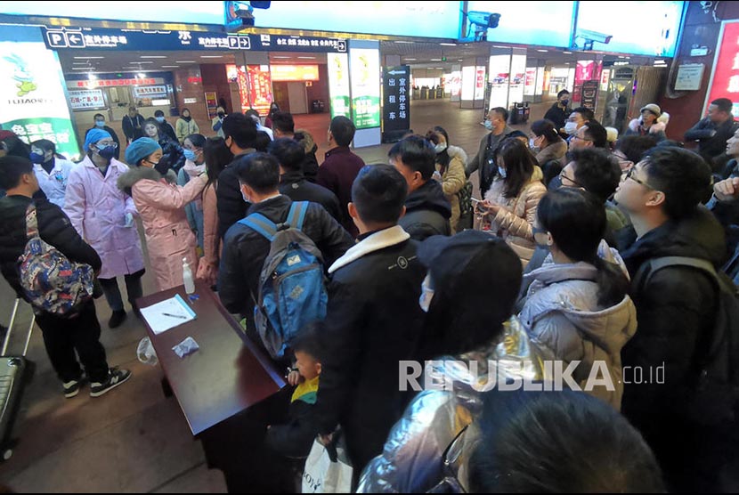 Petugas kesehatan memeriksan suhu tubuh calon penumpang  di Yingfan  City, Provinsi Jiangxi.   Wabah Virus Wuhan di China telah memakan korban 17 orang meninggal dan ratusan lainnya positif terjangkit.