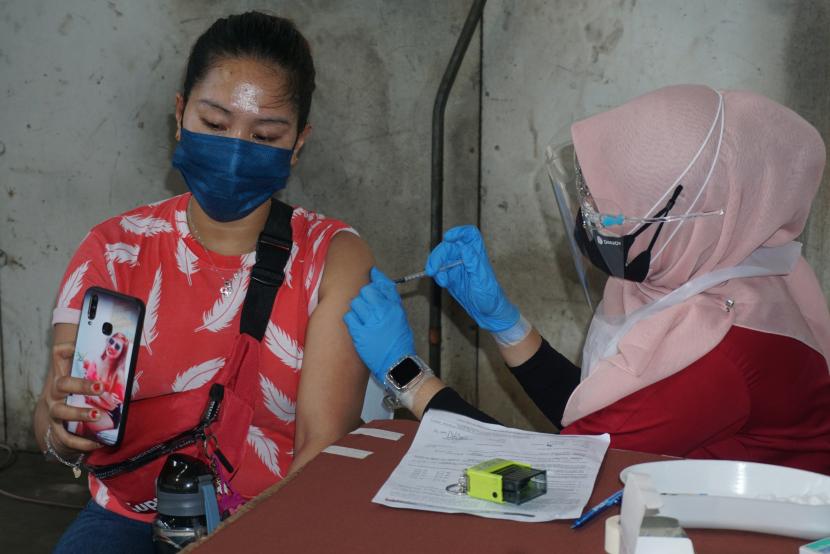 Petugas kesehatan menyuntikkan vaksin COVID-19 kepada seorang pekerja migran di Kongsi Kuala Lumpur, Taman Goodwood, Kuala Lumpur, Malaysia, Selasa (21/9/2021).
