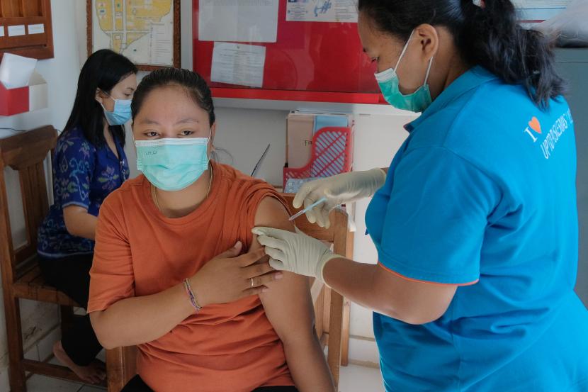 Petugas kesehatan menyuntikkan vaksin dosis ketiga kepada warga (ilustrasi)