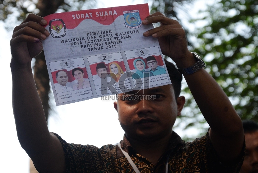 Petugas KPPS (Kelompok Penyelenggara Pemungutan Suara) menghitung kertas suara di TPS 44 Pemilukada Tangsel, Serpong, Tangsel, Rabu (9/12).