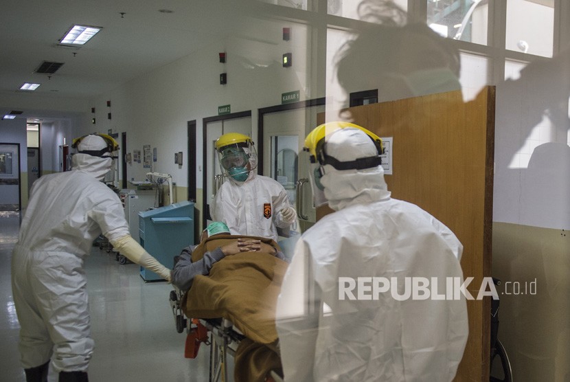 Petugas medis membawa pasien ke ruang isolasi saat simulasi penanganan pasien virus corona di RS Hasan Sadikin, Bandung, Jawa Barat, Jumat (6/3/2020).