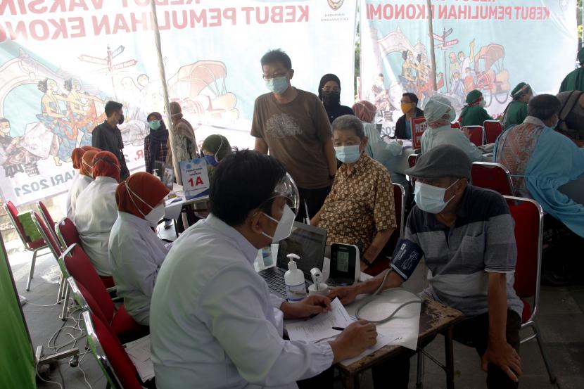 Petugas medis memeriksa kesehatan penerima vaksin COVID-19 untuk pedagang saat vaksinasi di Pasar Klewer, Solo, Jawa Tengah, Sabtu (27/2/2021). Sebanyak 3.800 pedagang Pasar Klewer dan 680 pedagang Pasar Gede Solo mengikuti Vaksinasi COVID-19 bertajuk Kebut Vaksinasi Kebut Pemulihan Ekonomi tersebut