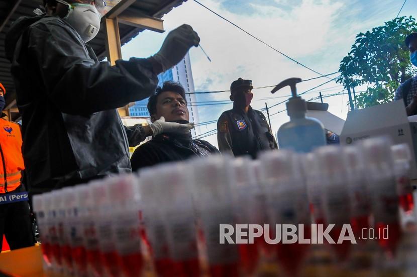 Petugas medis mengambil sampel penumpang KRL Commuter Line saat tes swab di Stasiun Bekasi, Jawa Barat, Selasa (5/5/2020). Tes swab yang dilakukan secara random untuk 300 penumpang dengan mengumpulkan cairan atau sampel dari bagian belakang hidung dan tenggorokan sebagai salah satu metode untuk mendeteksi dan mencegah penyebaran virus COVID-19 di transportasi umum. 