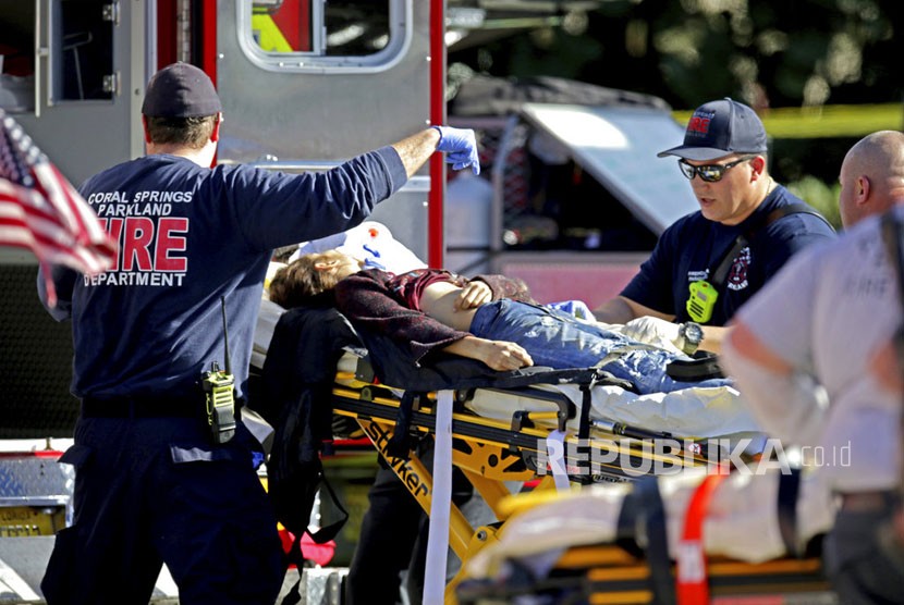 Petugas medis mengevakuasi korban penembakan di Marjory Stoneman Douglas High School di Parkland, Florida, Rabu (14/2). 