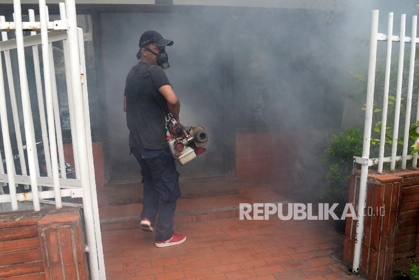 Petugas melakukan pengasapan (fogging) guna memberantas nyamuk penyebab demam berdarah di Kebon Sirih, Jakarta, Senin (8/2).  (Republika/Yasin Habibi)