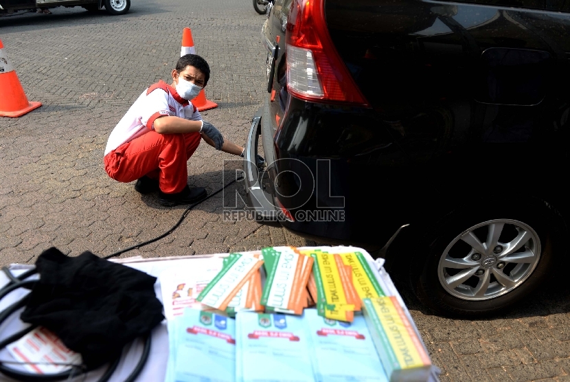 Petugas melakukan uji emisi kendaraan di kawasan Tugu Proklamasi, Jakarta, Selasa (6/10).   (Republika/Wihdan)