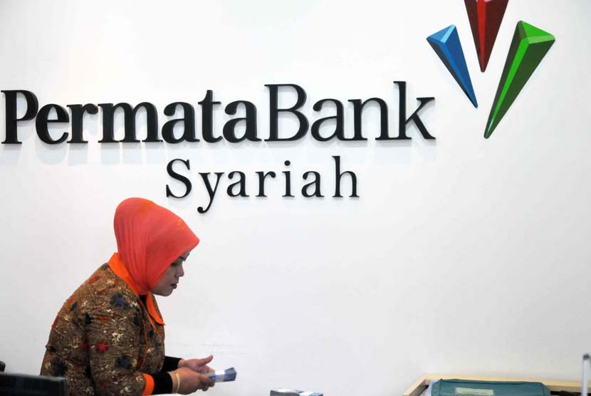 Petugas melayani transaksi nasabah di kantor layanan Bank Permata Syariah, Jakarta, Jumat (23/5).
