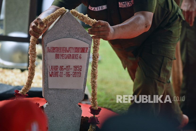 Petugas memasang rangkaian bunga melati pada nisan makam istri Presiden ke-6 RI Susilo Bambang Yudhoyono, Kristiani Herawati atau Ani Yudhoyono dalam upacara pemakaman di Taman Makam Pahlawan (TMP) Kalibata, Jakarta Selatan, Ahad (2/6/2019).
