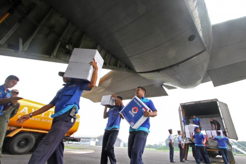 Petugas membawa bantuan logistik ke pesawat Hercules untuk korban Topan Haiyan di Filipina di Lanud Halim Perdanakusumah, Jakarta.