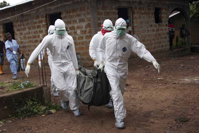 Petugas membawa jasad korban Ebola dari rumahnya di Monrovia, Liberia, Rabu (6/8) 