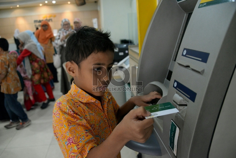 Petugas memberikan penjelasan kepada siswa kelas 5 sekolah alam Indonesia Jakarta saat melakukan kunjungan ke Bank Syariah Mandiri di Jakarta, Selasa (20/1).( Republika/Prayogi)