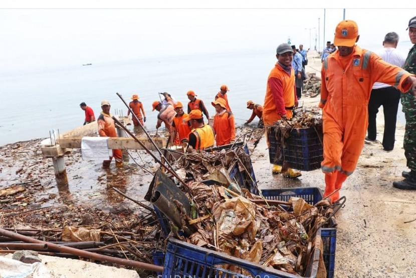 Ilustrasi petugas membersihkan sampah di Kepulauan Seribu.