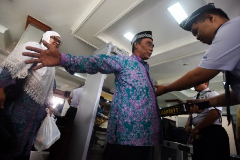 Petugas memeriksa jamaah calon haji sebelum diberangkatkan ke Bandara Juanda menuju Mekah di Asrama Haji Sukolilo, Surabaya, Jawa Timur, Jumat (21/8).