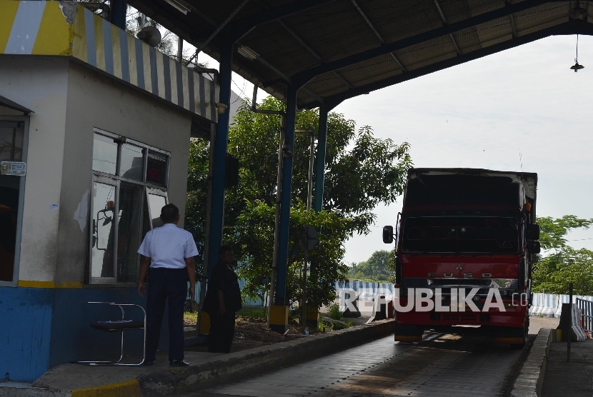 Petugas memeriksa surat-surat kendaraan di jembatan timbang Losarang, Indramayu, Jawa Barat, Senin (20/6). (Republika/Raisan Al Farisi)