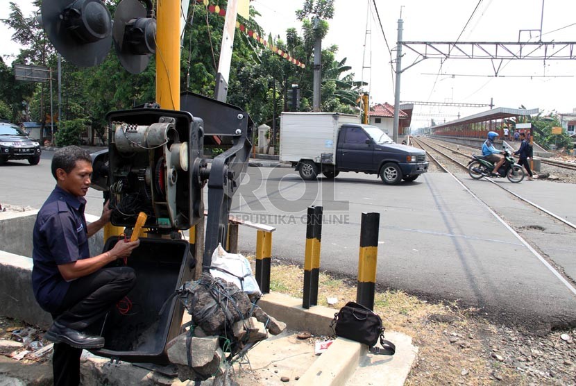 Petugas memperbaiki palang pintu kereta api di Grogol, Jakarta Barat, Senin (1/9). (Republika/ Yasin Habibi)