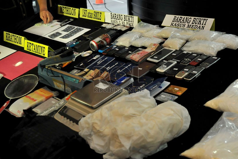   Petugas memperlihatkan barang bukti beserta tersangka jaringan narkoba internasional kepada wartawan di Jakarta, Senin (11/11).  (Republika/Prayogi)