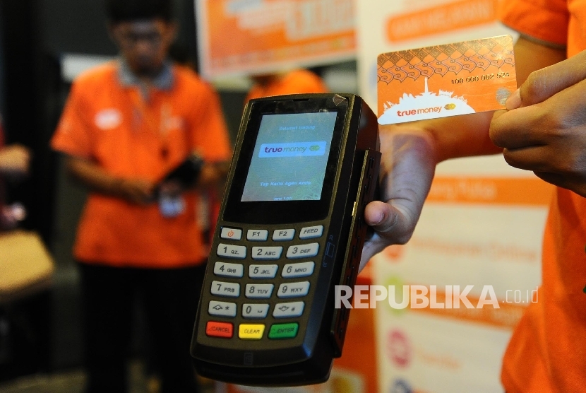 Petugas memperlihatkan penggunaan e-Money Witami Syariah dengan memakai alat EDC usai penyerahan sertifikat e-Money Syariah di Jakarta, Senin (28/3). (Republika/Tahta Aidilla)
