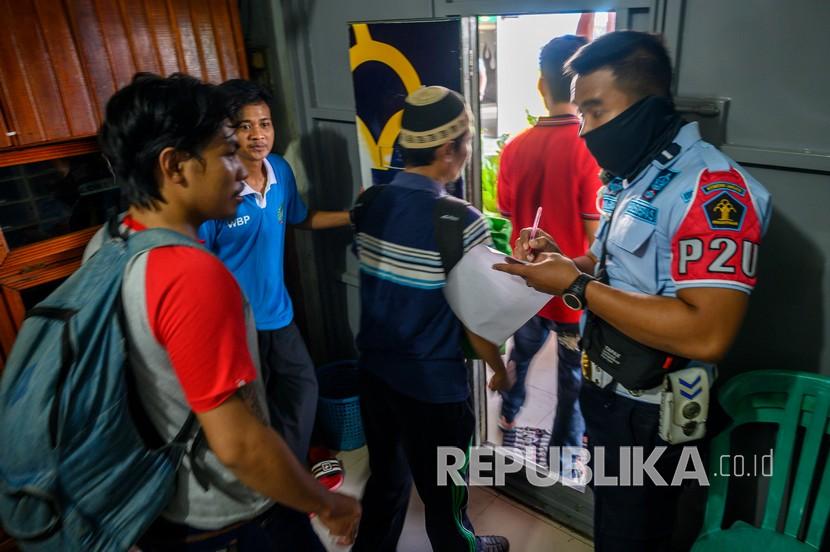 Petugas mendata warga binaan yang memenuhi syarat pembebasan keluar Rumah Tahanan (Rutan) Kelas IIA Maesa, Palu, Sulawesi Tengah, Kamis (2/4/2020). Kemenkum dan HAM mengeluarkan dari penjara 30.000 tahanan dewasa dan anak di seluruh Indoensia lebih cepat dari masa hukumannya dengan proses asimilasi dan integrasi di rumah untuk mencegah penyebaran COVID-19. 