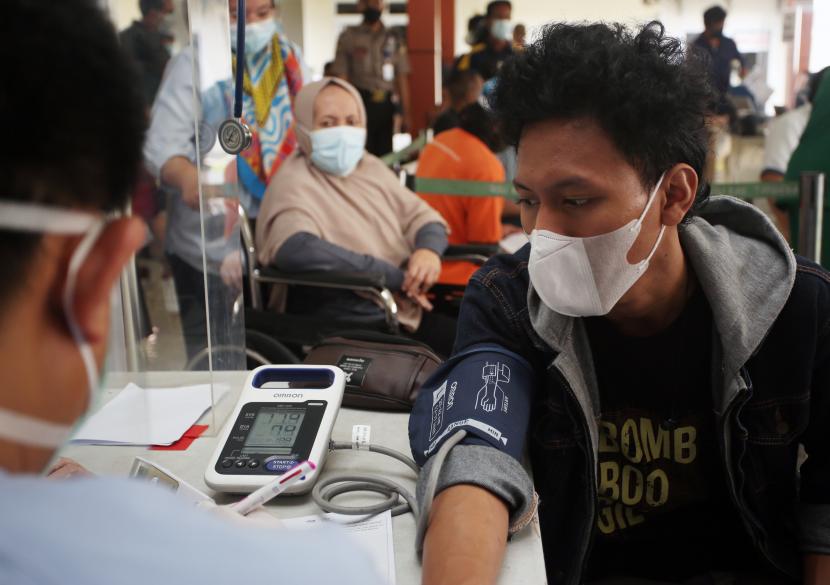 Petugas menedis memeriksa kesehatan warga penyinta kanker leukimia sebul dilakukan vaksin COVID-19 di RSUD Kabupaten Tangerang, Tangerang, Banten, Selasa (31/8/2021). RSUD Kabupaten mulai menyuntikan vaksinasi COVID-19 kepada penyintas kanker dan penderita hemofelia yang didampingi dokter khusus dari RSUD Kabupaten Tangerang sebagai usaha pembentukan herd immunity atau kekebalan kelompok di tengah mewabahnya COVID-19.