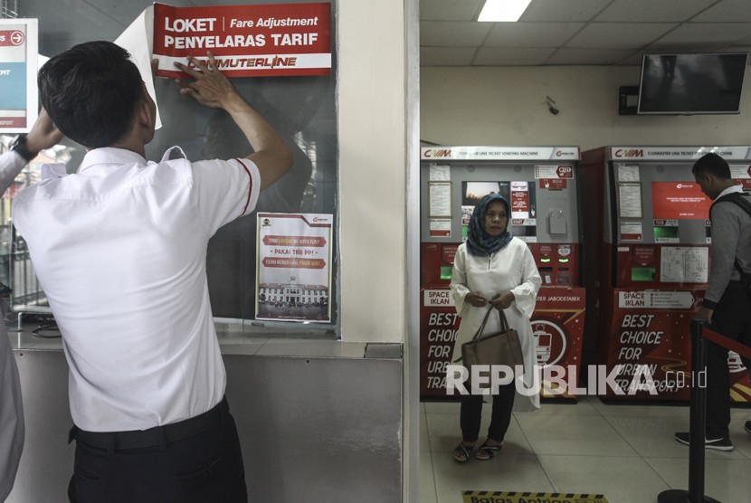 Petugas menempel stiker tentang penyelarasan tarif pada loket di Stasiun Juanda, Jakarta, Senin (8/1). PT Kereta Commuter Indonesia (KCI) mulai Senin (8/1), 