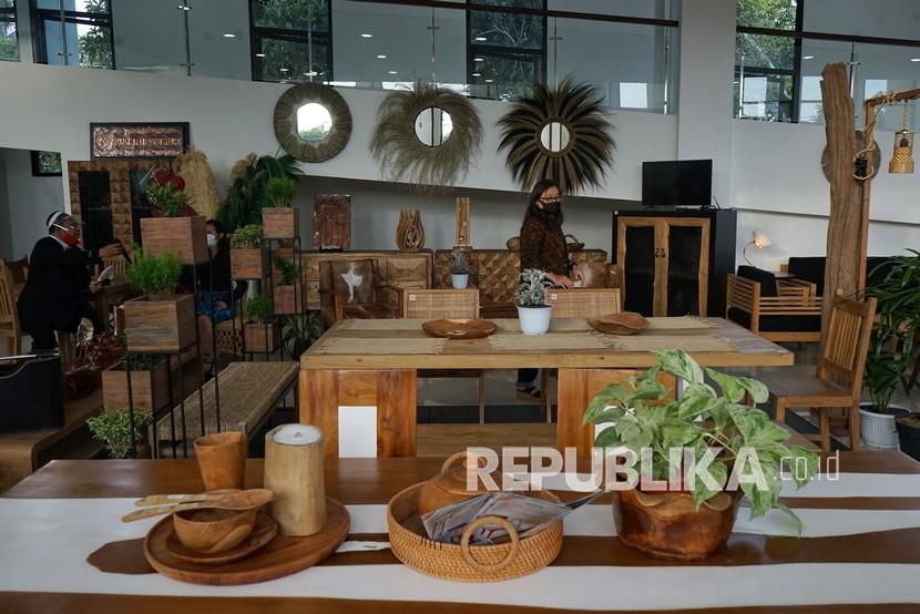Petugas mengamati produk yang dipamerkan saat pameran Kerajinan Mebel dan Batik di Sleman, DI Yogyakarta. Pameran menampilkan berbagai produk kerajinan UMKM Sleman. 